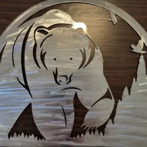 Metal wall art of a bear in the woods